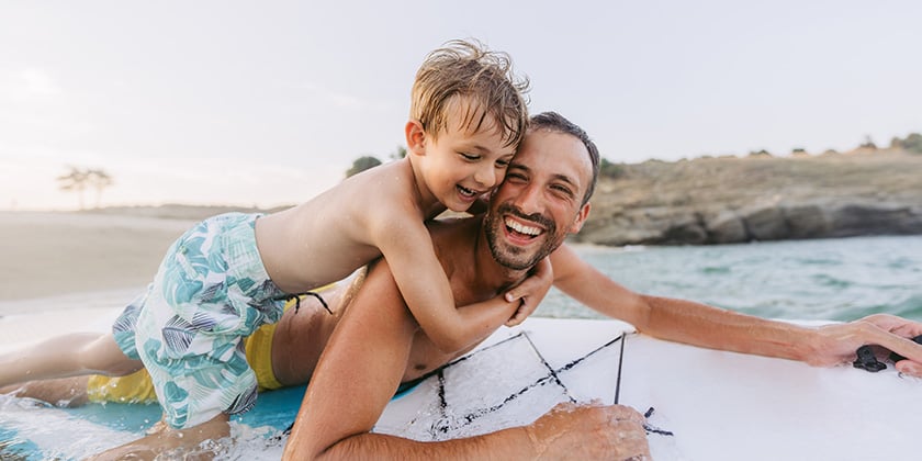 father and son playing in the ocean